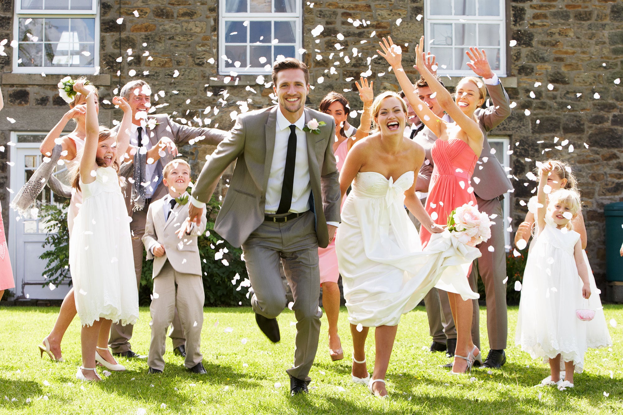 Bride and groom being tossed with flowers after the wedding