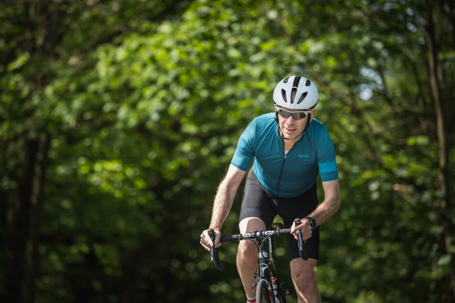 Middle-aged man keeping fit by biking