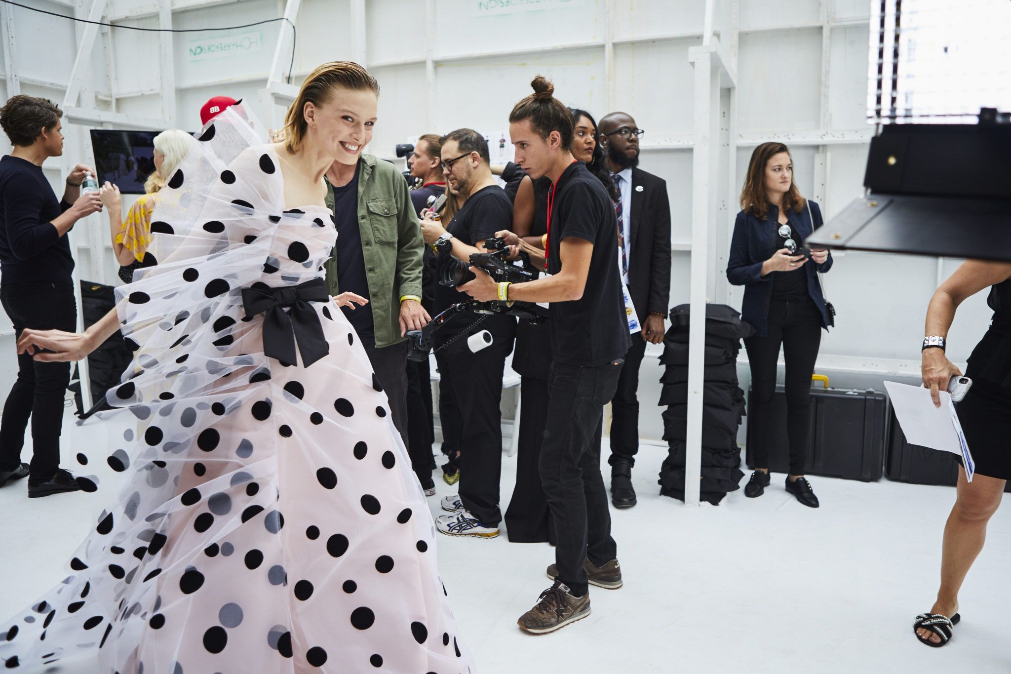 Woman in fashion show wearing a polka dot gown